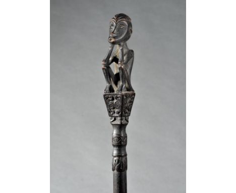 Kalimantan, Dayak, hunting charm, tun-tun, mounted with mythological figure and floral carving.  h. 53 cm. [1]