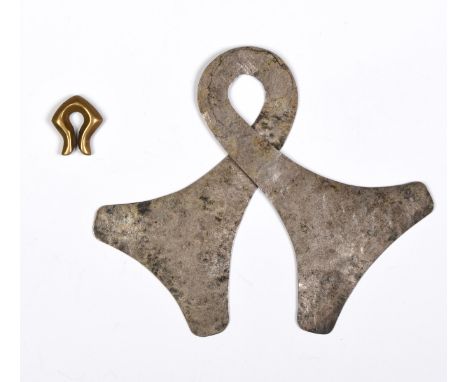 Sumba, two pendants, consisting of a silver pendant/ amulet, marangga,  twisted with two ax-head finials and a brass omega-sh