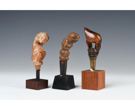 Lombok, three betel nut pestles, consisting of a horn male figure in crouching position, 19th century, one wooden handle show