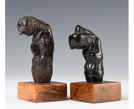 Northwest-Java, Cirebon, two fine wooden kris hilts, one item showing a squatting ancestor figure, traces of gold foil on det