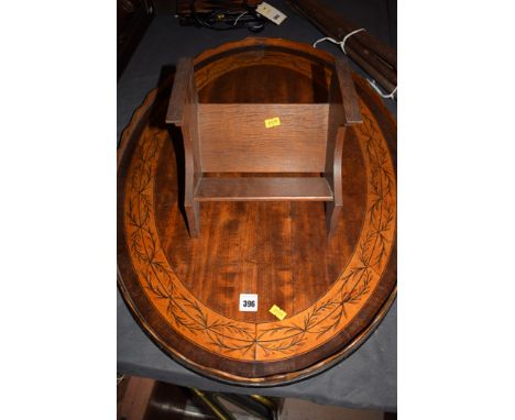 A late 19th Century inlaid mahogany oval tray shaped gallery with poker work decoration; and an oak book trough.  (2)