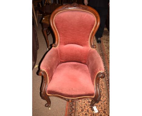 A gentleman's Victorian mahogany easy chair carved scrolling legs terminating in ceramic castors.