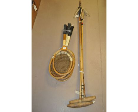 Three polo mallets, by J. Salter & Son, Aldershot; a walking cane; wooden tennis racquets by Dunlop and others.