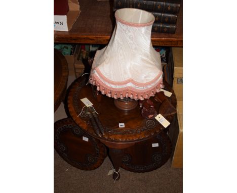 Three Indonesian circular carved hardwood tables; a similar lamp; nut cracker; and three figures.  (8)