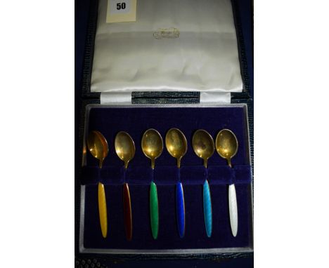 A set of six silver gilt and polychrome enamel teaspoons, probably Norwegian, retailed through Reid & Sons, Newcastle, cased.
