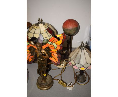 Art Deco style table lamps, in the form of a woman holding a globe and a woman with butterfly wings; together with two Tiffan