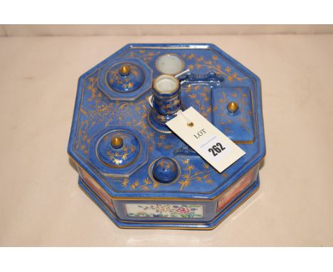 A 20th Century octagonal ceramic stationary tray, with candlestick, stamp holder, wax seal, ink pots, decorated with panels o