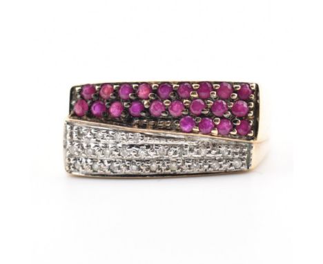 A hallmarked 9ct yellow ruby &amp; diamond cluster ring. The ring having an undulating crossover style rectangular head set w