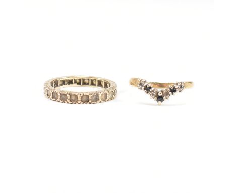 Two hallmarked 9ct gold gem set rings. A hallmarked 9ct gold eternity ring set with white stones together with a hallmarked s