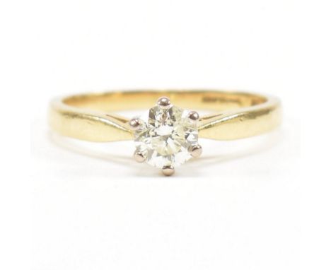 A hallmarked 18ct gold and diamond solitaire ring. The ring set with a single claw mounted diamond to chenier shoulders and t