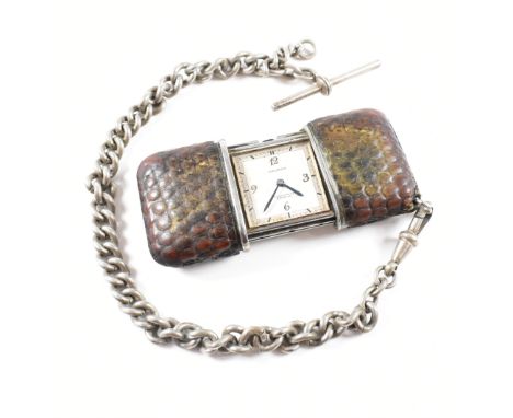 A 1930's Movado Chronometre Ermeto travel clock watch. The expanding sliding shutter snakeskin case having inset Movado watch