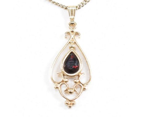 A contemporary hallmarked 9ct gold and garnet Art Nouveau style pendant necklace. Weight 3.6g. Chain measures 48cm. Pendant m