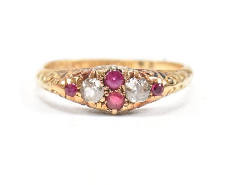 A hallmarked Victorian 18ct gold gem set ring. The ring set with rubies and diamonds with one paste replacement stone to scro