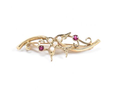 A hallmarked 9ct gold ruby and pearl brooch pin with swallow motif. Weight 2.8g. Measures 3.8cm.&nbsp;All weights, measuremen