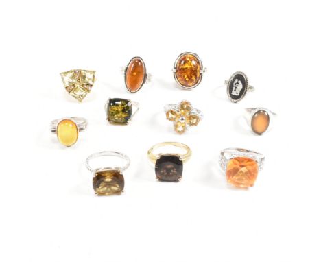 A collection of 925 silver and gem set rings. The rings to include citrine, smoky quartz, amber, CZ, solitaire, pierced, flor