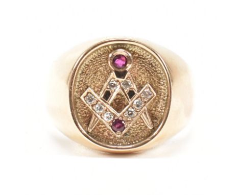 An 18ct yellow gold, diamond &amp; ruby set Masonic signet ring. The ring having an oval head with diamond &amp; ruby set Mas