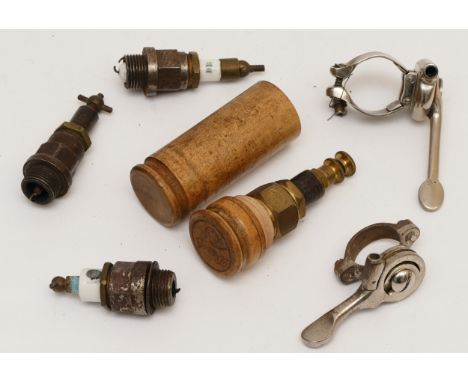 A veteran Darop brass spark plug, in wooden case, three other vintage spark plugs and and two levers 
