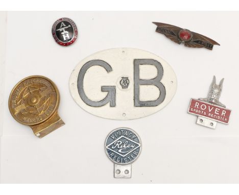 A Morris Eight badge, a Rover Sports Register alloy and enamel badge, a Vintage Riley Register badge, two other badges and an