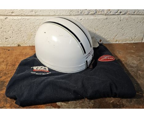 A Cromwell cork pudding basin helmet, with Moto Guzzi sticker, size 7 1/4 and a Moto Guzzi shirt, size L 