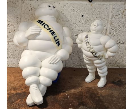 A Bibendum or Michelin Man plastic seated lamp, lacking lighting, 50cm and a standing example, 31cm (2) 