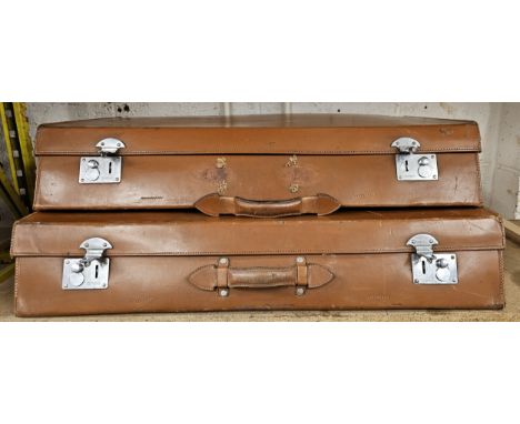 A two piece tan leather trunk set, 82 x 58 x 15cm and 82 x 48 x 15cm (2) 
