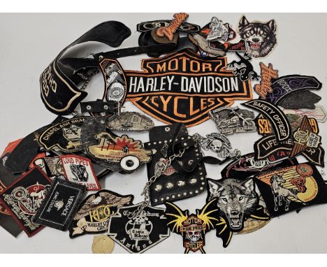 A collection of Harley Davidson ephemera, including two belt buckles a wallet and patches. 