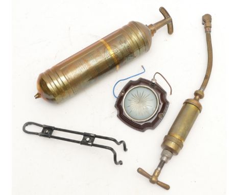 A Pyrene brass fire extinguisher with mounting bracket, a Tecalemit Type 41 grease pump and a vintage Bakelite interior light