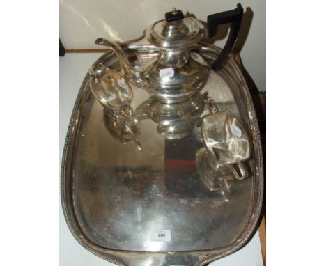 A silver plated gallery tray, 62 cm wide, and a silver plated three piece tea service (4)