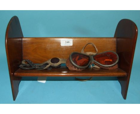 A propeller book trough, believed to be from a Tiger Moth, 35 cm high, a German pilot's leather microphone strap, and a pair 