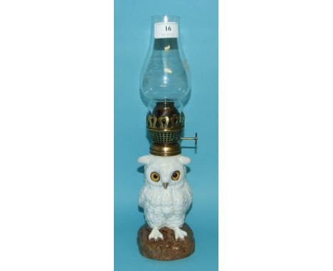 An oil lamp base, in the form of an owl, with a clear glass flute, 35 cm high