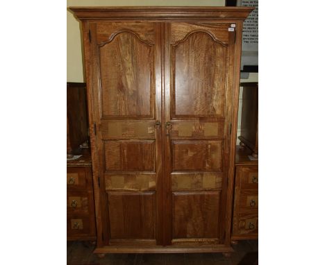 A matching two door wardrobe, on bun feet, 122 cm wide