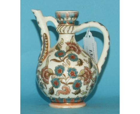 A Zsolnay Pecs ewer, with stylised floral decoration, with blue factory marks to base (chipped), 12.5 cm high