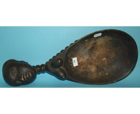 An African carved wood figural ladle, 56 cm