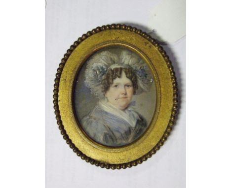 An oval bust portrait miniature, of a lady in mourning dress, watercolour on ivory, 7 x 5.5 cm, and another similar of a youn