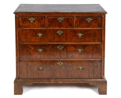 A walnut chest, with feather crossbanding, having three short and three graduated long drawers, on bracket feet, 98 cm wide  