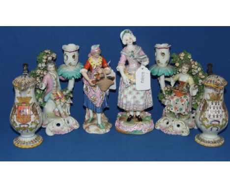 A Berlin style porcelain figure, of a lady, 21 cm high, another similar figure, a pair of figural candlesticks, and a pair of