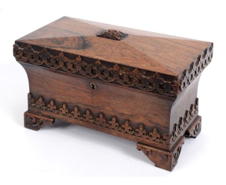 A Victorian rosewood tea caddy, of sarcophagus form, with Gothic style carved decoration, 33 cm wide  See illustration