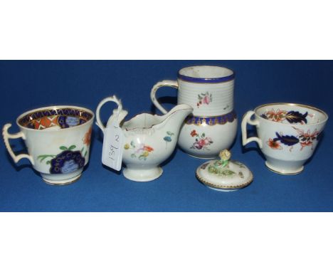 A Derby mug, with painted and gilt decoration, 9.5 cm high, a Derby style porcelain dolphin shaped jug, 7.5 cm high, two teac