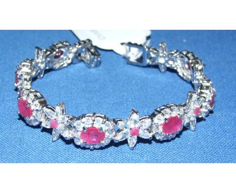 A silver, ruby and white stone bracelet