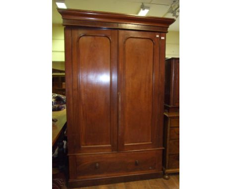 A Victorian mahogany wardrobe, having a pair of panelled doors above a drawer, 136 cm wide