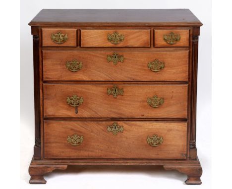 A George III mahogany chest, of two short and three graduated long drawers, flanked by quadrant fluted pilasters, and on ogee