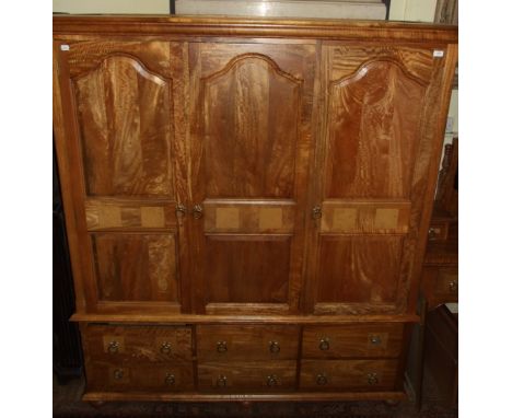 A good quality modern inlaid wardrobe, in the 18th century taste, having three panel doors above four short drawers and a sma