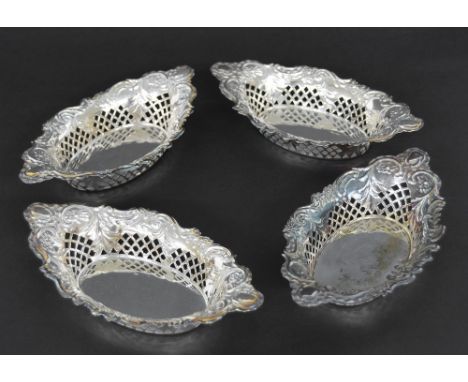 Set of four late Victorian silver oval trinket dishes, repousse with scrolling foliage and with pierced lattice sides, maker 