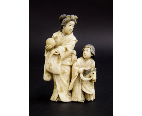 Japanese ivory okimono of a mother and child, standing in typical dress with the daughter riding a hobby horse, Meiji period,