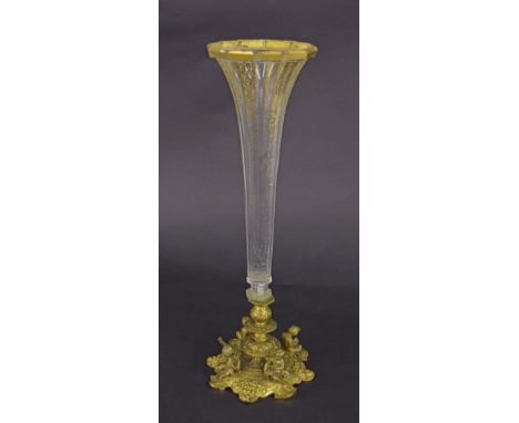 19th century ormolu and glass epergne, the gilt cast base modelled with masks and four cherubs surmounted with a fluted gilde