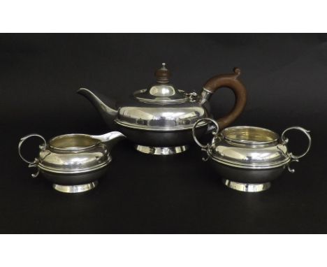 Silver three piece bachelor tea service of squat form decorated with a reeded band, maker William Neale & Son Limited, the te