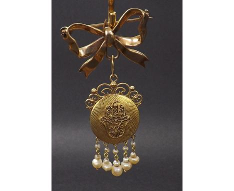 Attractive gold engine turned circular locket pendant, with filigree decoration and pearl tassels, with a later 9ct bow brooc