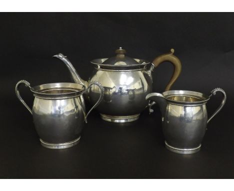 Silver three piece tea service of plain ovoid form with beaded decoration, maker Charles Boyton & Son Limited, London 1926, t