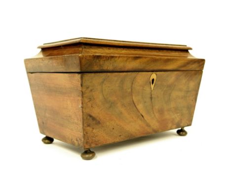 19th century mahogany tea caddy of sarcophagus form upon bun feet, 12" wide