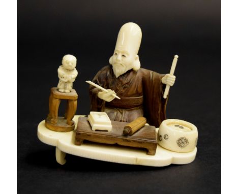 Japanese small ivory and hardwood okimono, modelled as a scholar kneeling at a low table on a lobed ivory base, signed, Meiji